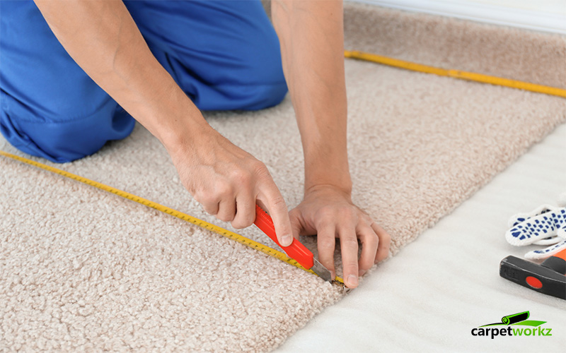 Worker Installing Carpet Tiles