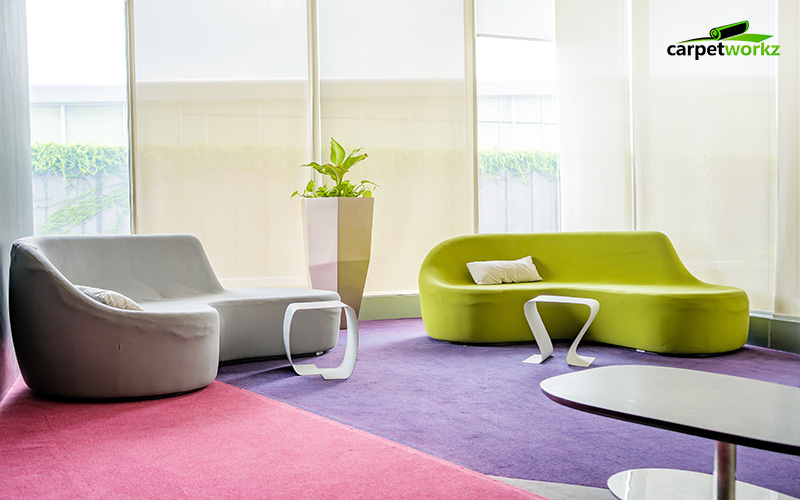 Modern office lounge with colourful carpet zones in purple and pink