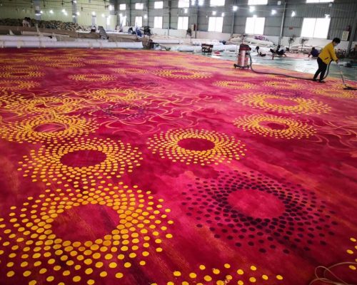 A large tufted carpet with yellow circles on it.